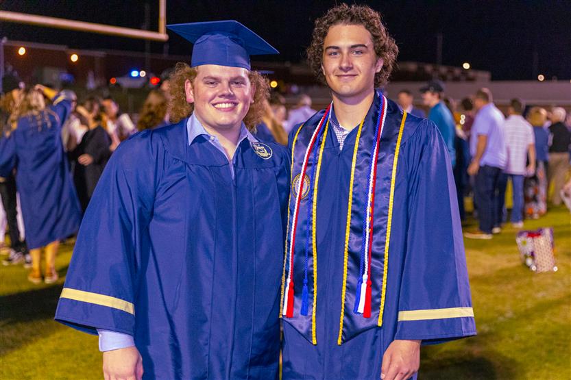 Students wearing blue graduation robes